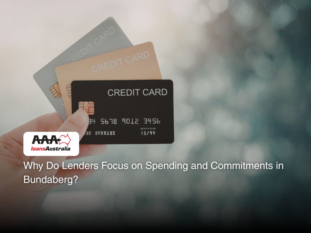 A hand holding 3 credit cards.