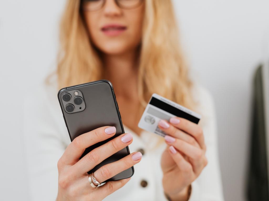 A person checking credit score on her phone.