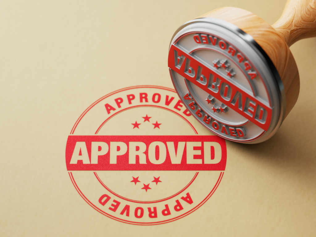 An approved stamp on a sheet of paper.