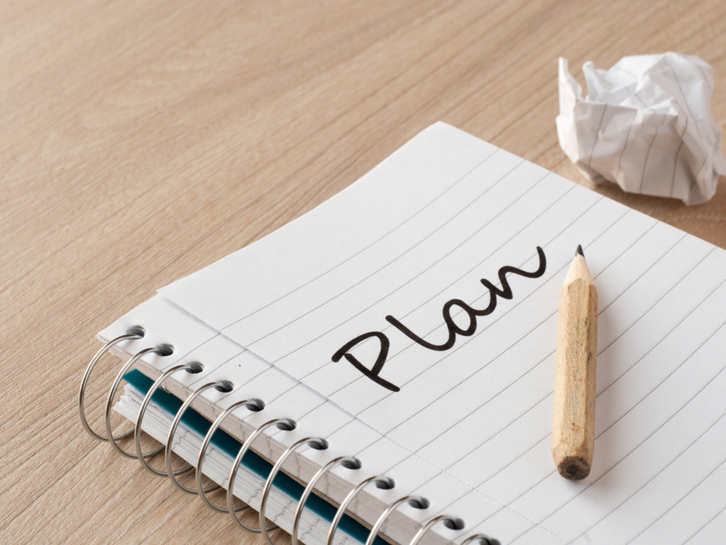 A notebook showing a writing of the word "plan"