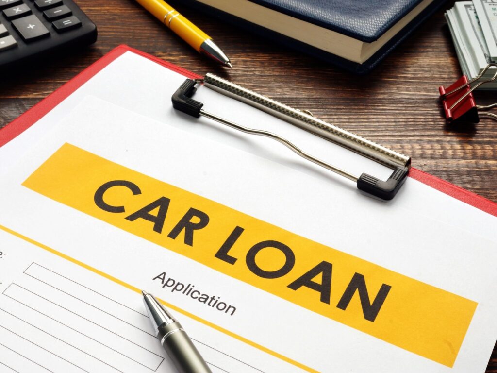 Customer discussing vehicle finance options with a loan specialist