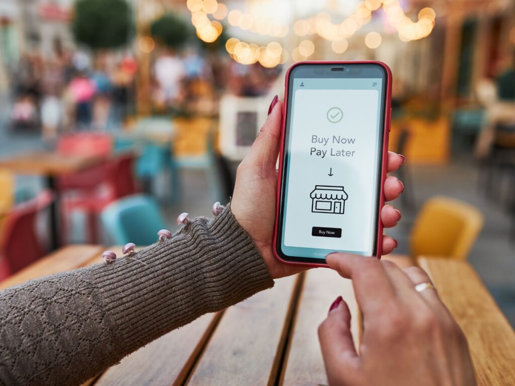 Person reviewing Buy Now, Pay Later repayments before applying for a loan