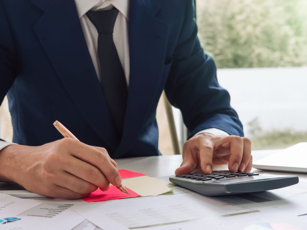 Person organising financial documents and repayments before a loan application